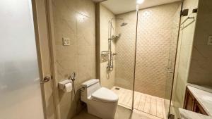 a bathroom with a toilet and a glass shower at The LH Homestay in Phú Quốc