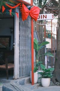 a red bow on a pole in front of a door at Jin homestay in Thôn Lại Thê