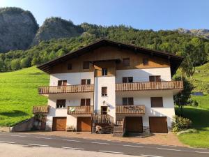 a building with balconies on the side of a mountain at Casa Mirabella in Sottoguda
