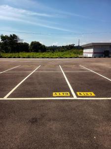 an empty parking lot with yellow signs on it at IFS Soho 3 Basic Home in Seri Iskandar +7 photos
