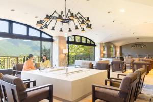 a restaurant with a large window and people sitting at a table at TAOYA Hakone in Hakone