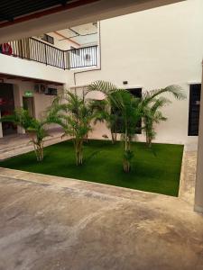 a group of palm trees in a building at IFS Soho 3 Basic Home in Seri Iskandar