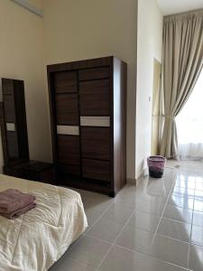 a bedroom with a large wooden dresser and a bed at NHI Home Paka in Paka