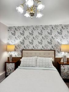 a bedroom with a bed and a chandelier at 2BR sweet suite in Nanaimo