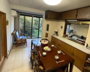 a kitchen with a table and a dining room at 丸亀 Sawai 一棟貸し 丸亀駅徒歩 10人まで宿泊可能 駐車場2台有 子供部屋ベビーベッド有 in Marugame
