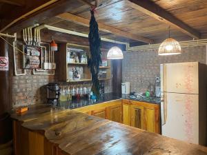 a kitchen with a wooden counter and a refrigerator at little Island in Na Lúng