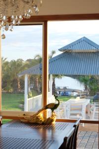 a table with a view of the ocean through a window at Bloom by the Bend in Tooradin