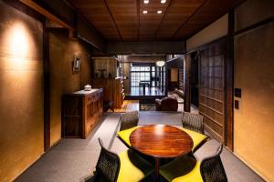 a dining room with a wooden table and chairs at Rinn Kyoto Imperial Palace South Kishoan in Kyoto +17 photos