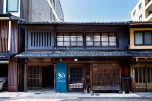 a building with a blue door on a street at Rinn Kyoto Imperial Palace South Kishoan in Kyoto