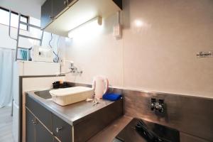 a kitchen with a sink and a counter top at Mary's Room Sumiyoshi in Sumiyoshi