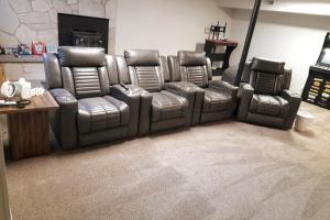 a set of leather reclining chairs in a living room at The Gate City Grande in Pocatello