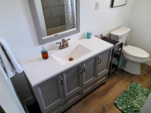 a bathroom with a sink and a toilet at The Gate City Grande in Pocatello +31 photos