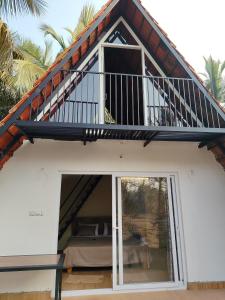 a view of a house with a balcony at Arundekar's Cottage in Gokarna
