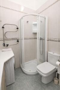 a bathroom with a shower and a toilet and a sink at La casilla de Miguel con jardín privado y piscinas in Denia +44 photos