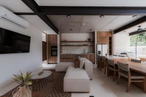 a living room with a couch and a table at The Town at Praia in Jacó