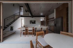 a kitchen and dining room with a table and chairs at The Town at Praia in Jacó