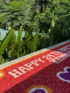 a flower carpet with the words happy spring on it at 3BR Nava villa Ubud in Ubud