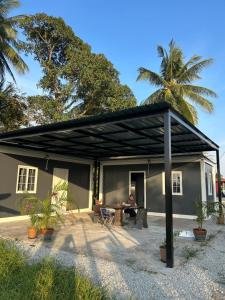 a man sitting in a patio of a house at TeeDo Zzz in Parit Buntar