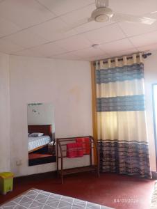 a room with a bed and a mirror and a curtain at Our Little Secret in Kalutara +43 photos