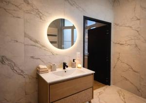 a bathroom with a sink and a mirror at Spacious & Luxuary Studio in Amiens +6 photos