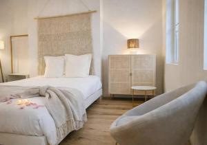 a bedroom with a large bed and a chair at Spacious & Luxuary Studio in Amiens