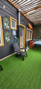 a patio with a bench and a table and a television at Maitencillo Shelter in Puchuncaví