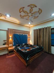 a bedroom with a large bed and a chandelier at The Sapphire Retreat in Srinagar