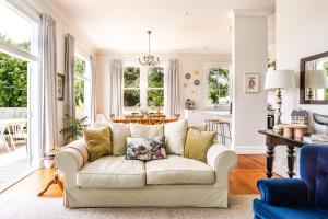 a living room with a couch and a table at Britannia Villa in Greytown
