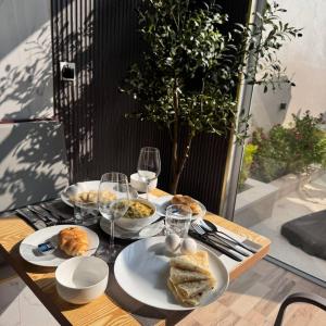 a table with plates of food and glasses of wine at Villaasa in Shaviyani Atoll