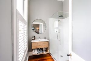 a bathroom with a sink and a mirror at Britannia Villa in Greytown +16 photos