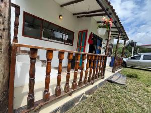 a house with a wooden fence in front of it at Mirador De Las Pirámides in Zetaquira +59 photos