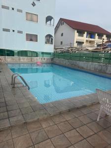 a swimming pool in front of a building at Skippers beach guesthouse in Hua Hin