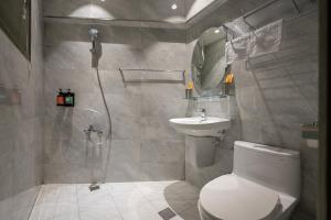 a bathroom with a toilet and a sink and a shower at SMilE WAVE in Xiaoliuqiu +52 photos