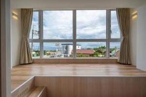 an empty room with a large window with a view at SMilE WAVE in Xiaoliuqiu