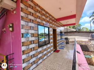 a brick wall with a window on a building at D'Souza Home stay in Māvalli