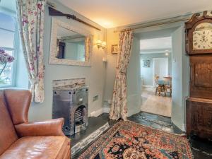 a living room with a couch and a fireplace at Howe Cottage in Bowness-on-Windermere