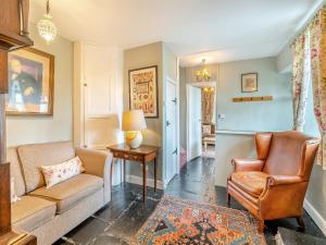 a living room with a couch and chairs and a table at Howe Cottage in Bowness-on-Windermere