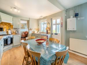 a kitchen and dining room with a table and chairs at Howe Cottage in Bowness-on-Windermere +17 photos