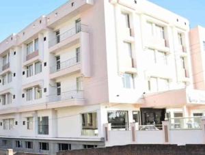 a large white building with balconies on it at Kanta International near katra railway station in Katra