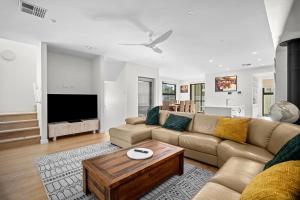 a living room with a couch and a table at Harborview Modern Apartment 8F in Victor Harbor