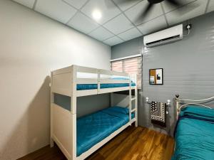 a room with two bunk beds and a bed at QUDWAHSTAY in Kota
