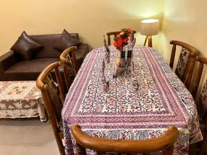 a table with a table cloth and flowers on it at Sheetal Homestay in Varanasi