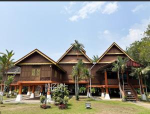a building with palm trees in front of it at QUDWAHSTAY in Kota