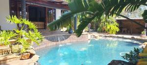 a swimming pool with a waterfall in a yard at Belle-áme Self catering Accommodation in George