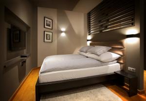 a bedroom with a bed with a black headboard at Gateway Budapest Centrum in Budapest