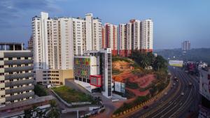 an aerial view of a city with tall buildings at Nestlay Suites by TC One in Kozhikode