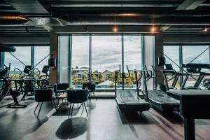 a gym with cardio equipment and a large window at Delfins Beach Resort Bonaire, Tapestry Collection by Hilton in Kralendijk