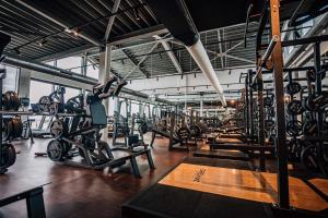 a gym with rows of exercise bikes and weights at Delfins Beach Resort Bonaire, Tapestry Collection by Hilton in Kralendijk