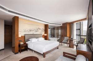 a hotel room with a bed and a bathroom at SSAW Boutique Hotel Dexin Mogan Mountain in Deqing +54 photos