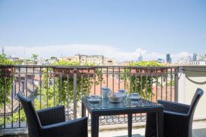 a table and chairs on a balcony with a view at Hotel Manzoni in Milan